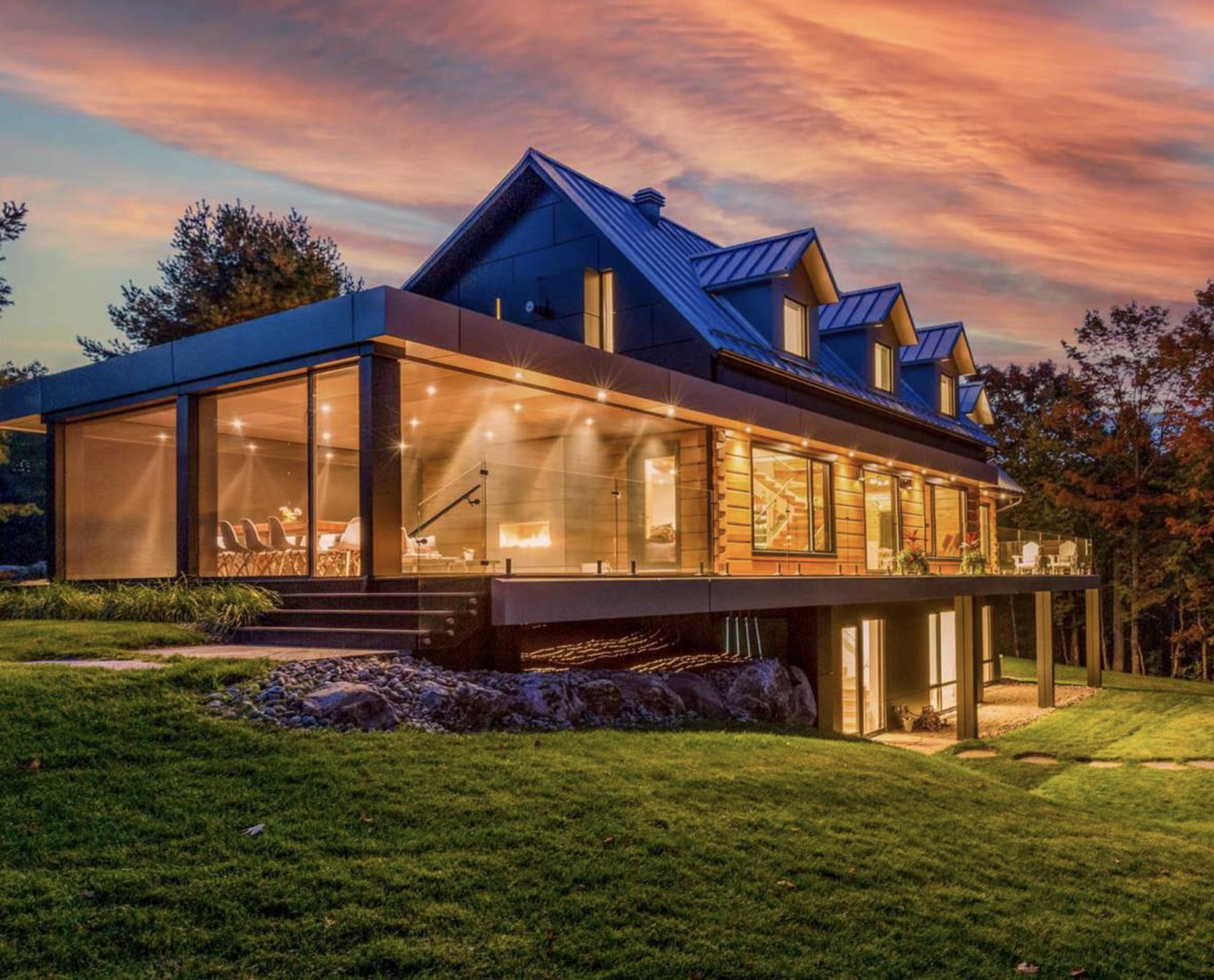 Modern log cabin retreat exterior at dusk