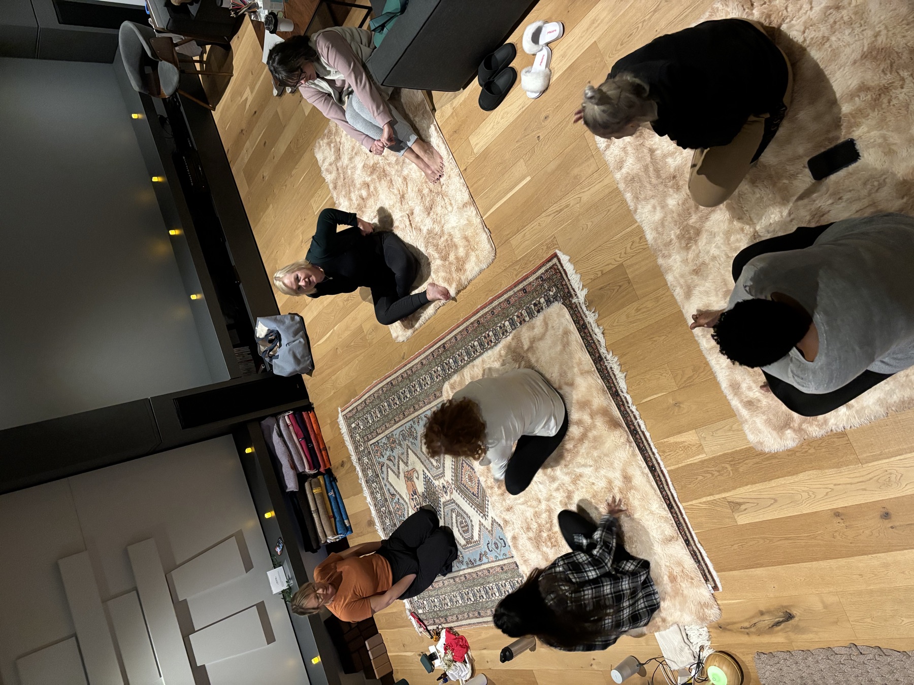 Workshop participants seated in a circle on the floor