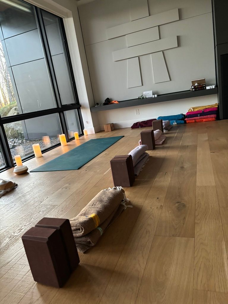 Candlelit yoga studio set with mats, blocks and blankets